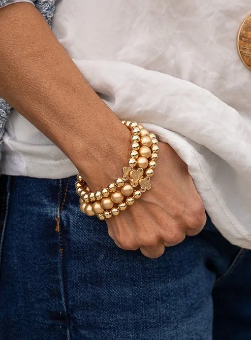 Matte And Shiny Gold Three Piece Bracelet Set With Clover