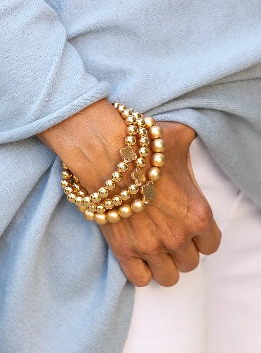 Matte And Shiny Gold Three Piece Bracelet Set With Clover
